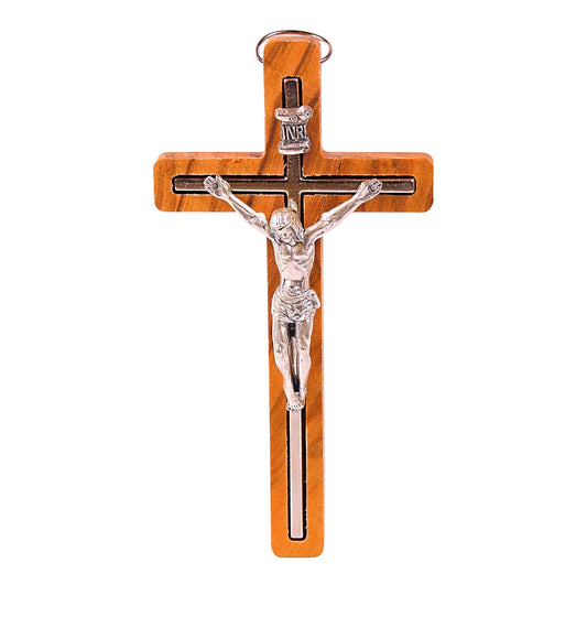 A 'Calvary's Legacy' Olive Wood Crucifix, measuring 12 cm in height and 6.5 cm in width. It features a detailed silver-colored figure of Christ affixed to the warm, grainy surface of the olive wood, with the traditional INRI inscription above. Handcrafted by Christian families in the Holy Land, the crucifix combines spiritual significance with artisanal beauty.