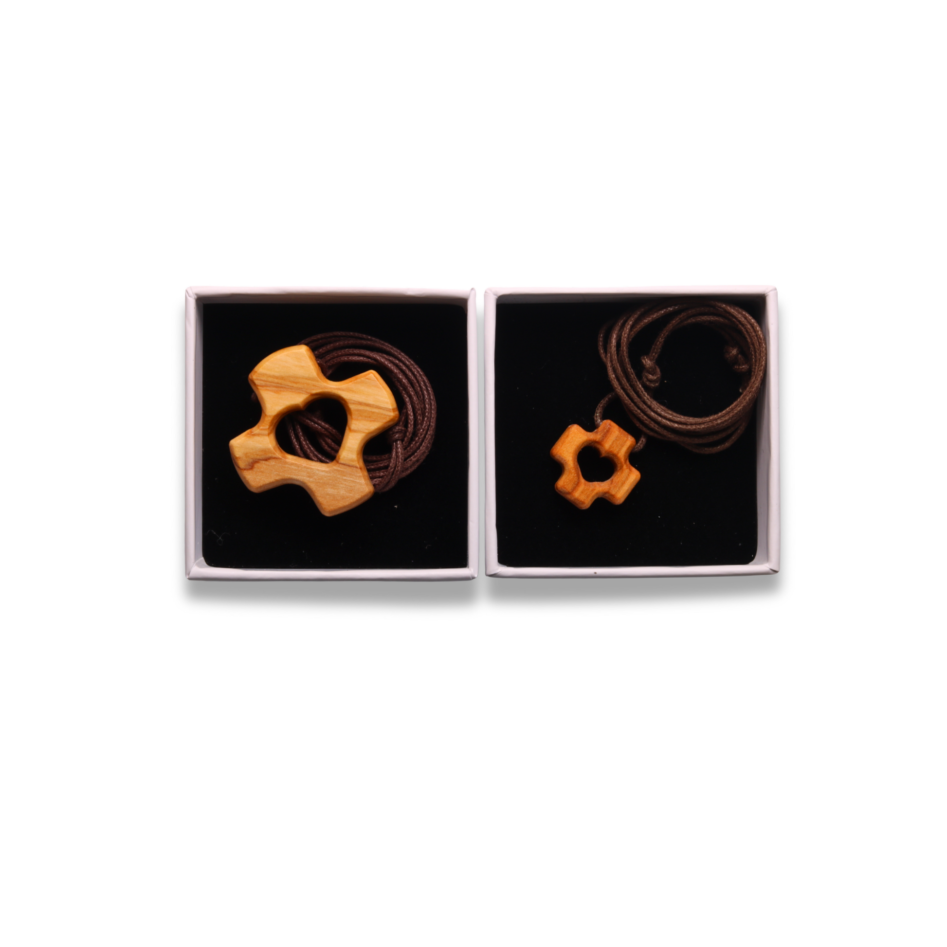 Two olive wood cross pendants with heart cutout on a white background, in gift box
