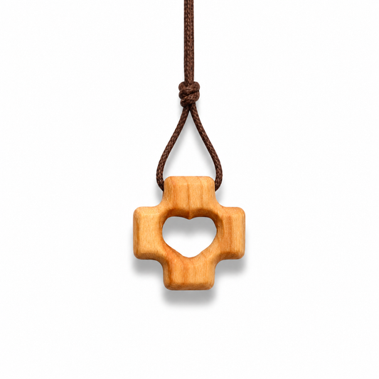 Wooden pendant on a brown cord against a white background