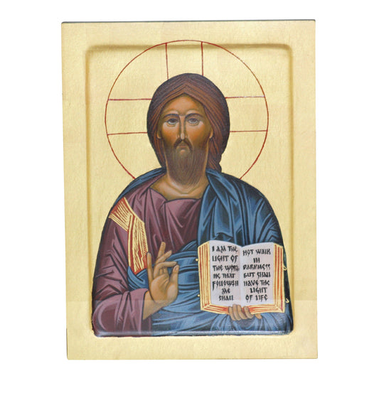 Traditional Byzantine-style icon of Christ depicted from the waist up, holding an open book with a red cover displaying a quote from John 8:12 in black letters. He is robed in a deep blue and reddish-purple garment, with a raised right hand in blessing. A golden halo with a cross surrounds his head against a gold background.