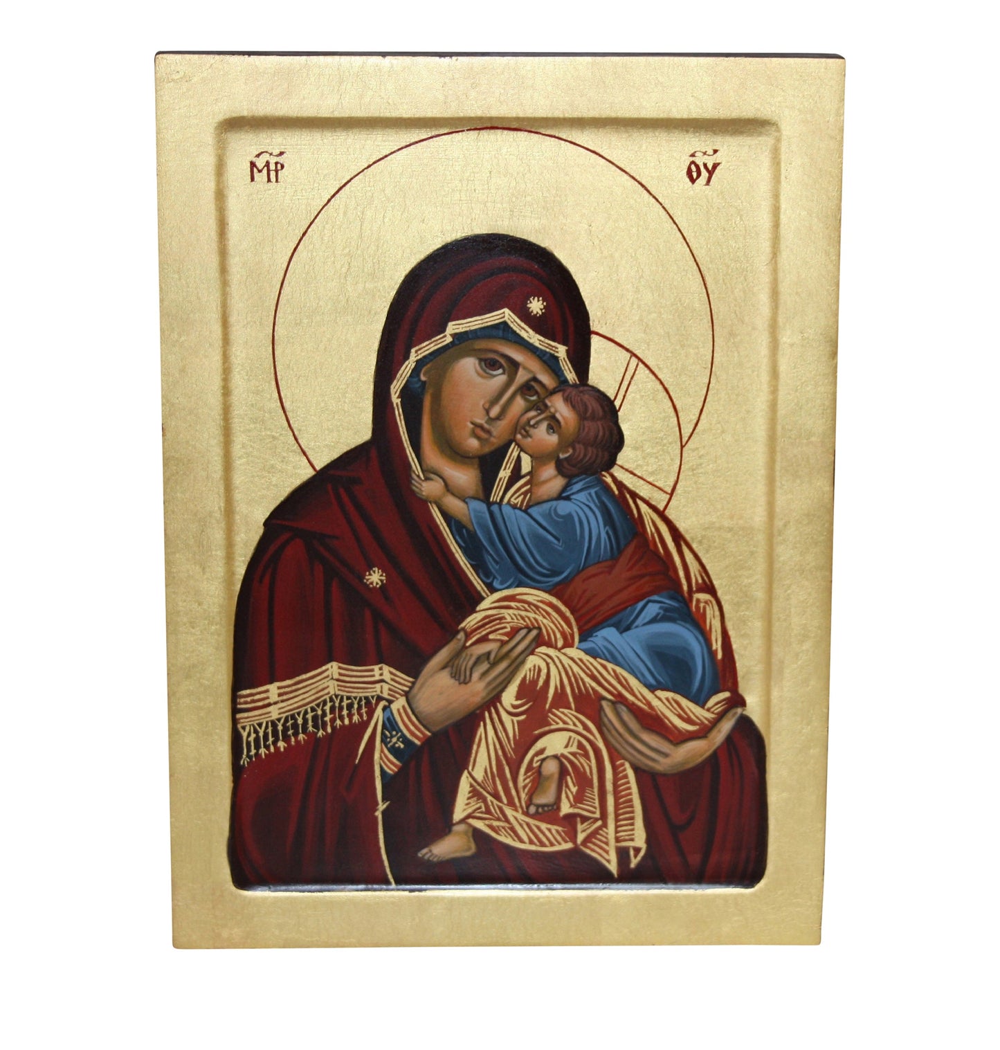 Hand-painted Eastern Orthodox icon of the Virgin Mary and Child Jesus. Mary, in a deep red robe with golden patterns and a dark veil, holds Jesus, wearing a blue tunic with gold trim. Both have golden halos, Mary's inscribed with MP ΘΥ, and Jesus' with ΟΩΝ. The background is gold leaf, with a simple gold border framing the icon.