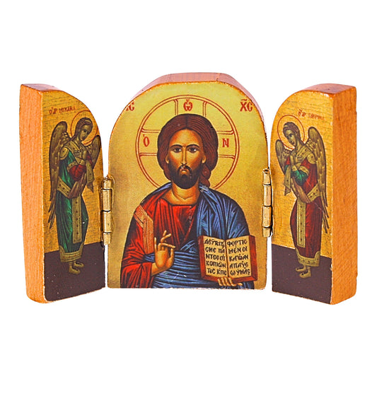 A triptych religious icon with gold-leaf background. The central panel depicts Jesus Christ with a halo, blessing with his right hand and holding the Gospels in his left. The side panels, acting as doors, show full-length figures of angels facing toward Christ. The icon is detailed with traditional Orthodox Christian symbolism, set within a natural wooden frame with metal hinges.