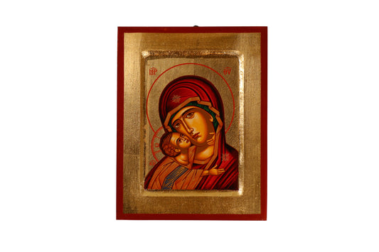 A hand-painted icon of the Virgin Mary in a red robe cradling the infant Jesus against a golden background, within a red frame. Mary has a contemplative expression and a halo inscribed with "MP OY," while Jesus looks outward with a hand raised in blessing and a halo with a cross.