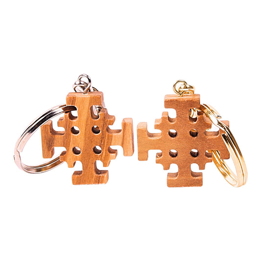 Olive wood Jerusalem Cross keychains, one with a silver ring and the other with a gold ring, showcasing the central cross potent surrounded by four smaller Greek crosses.