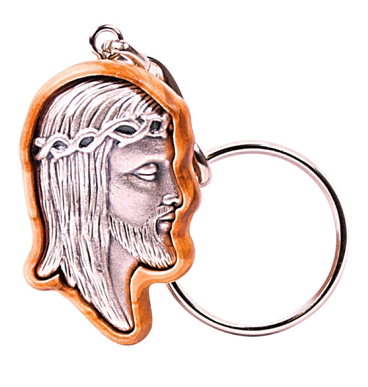 Olive wood keychain featuring a detailed silver-toned metal face of Jesus with a crown of thorns, set within an intricately carved wooden frame.