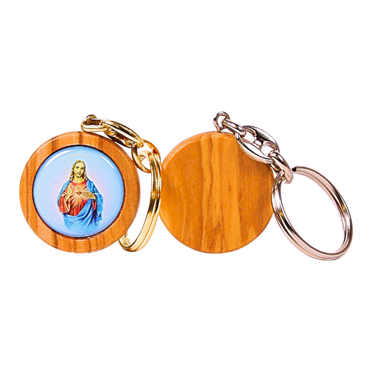 Olive wood keychain with a colorful illustration of the Sacred Heart of Jesus in a circular frame, attached to a metallic key ring.