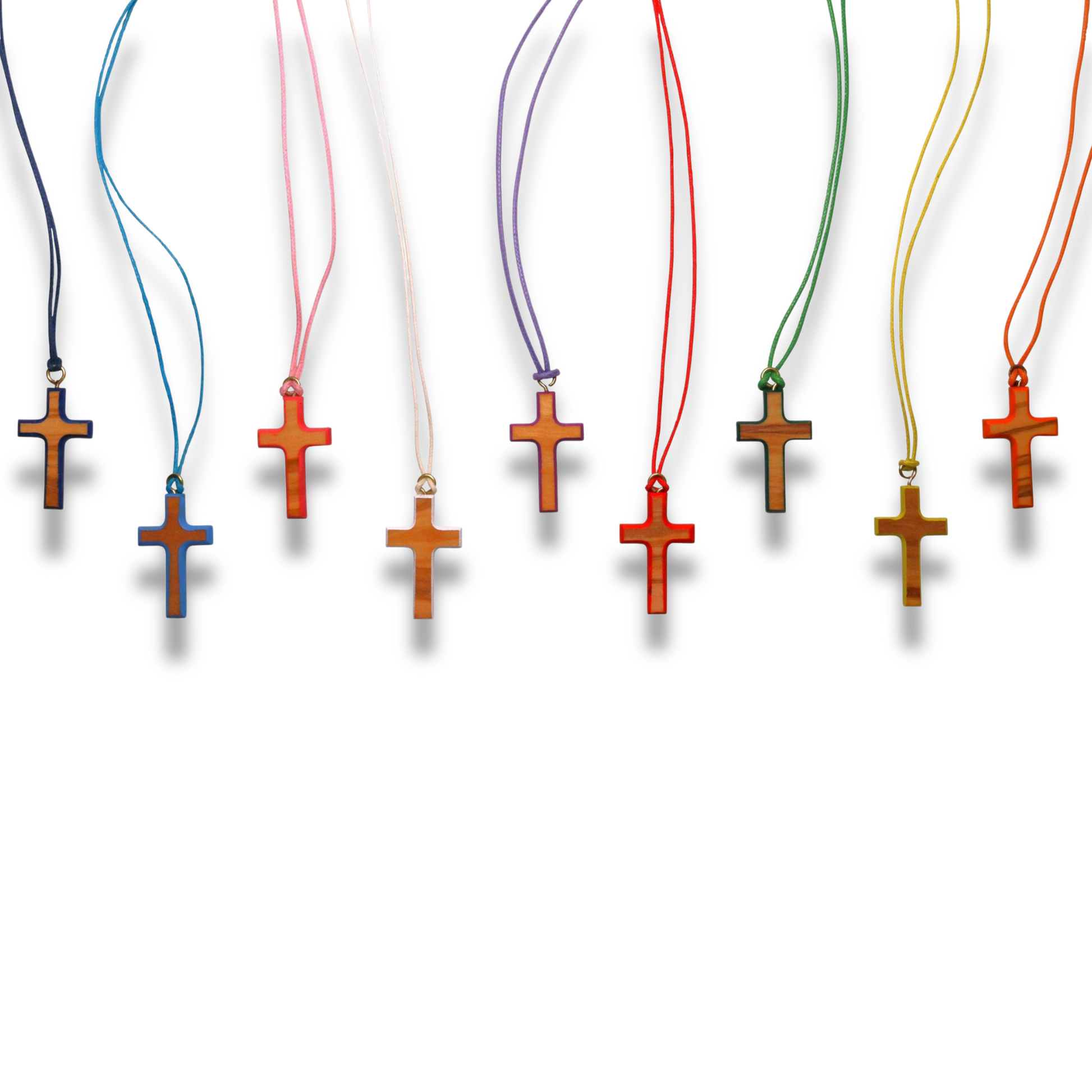 Row of colorful wooden cross necklaces against a white background