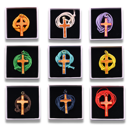 Nine colorful olive wood crosses on a white background