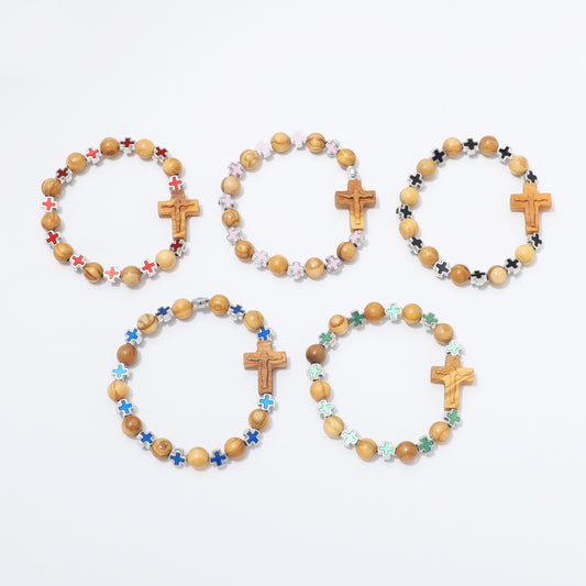 Five wooden bead bracelets with wooden cross charms and colorful star beads, arranged on a plain white background.