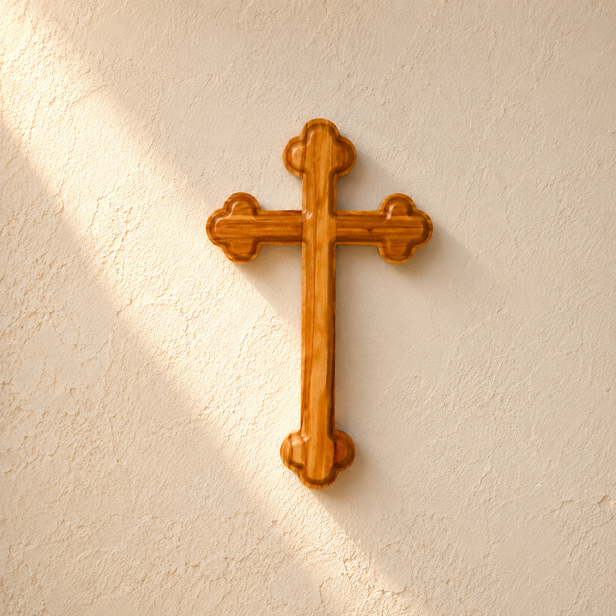 An Olive Wood Orthodox Wall Cross, mounted on a textured off-white plaster wall with soft sunlight and shadow.