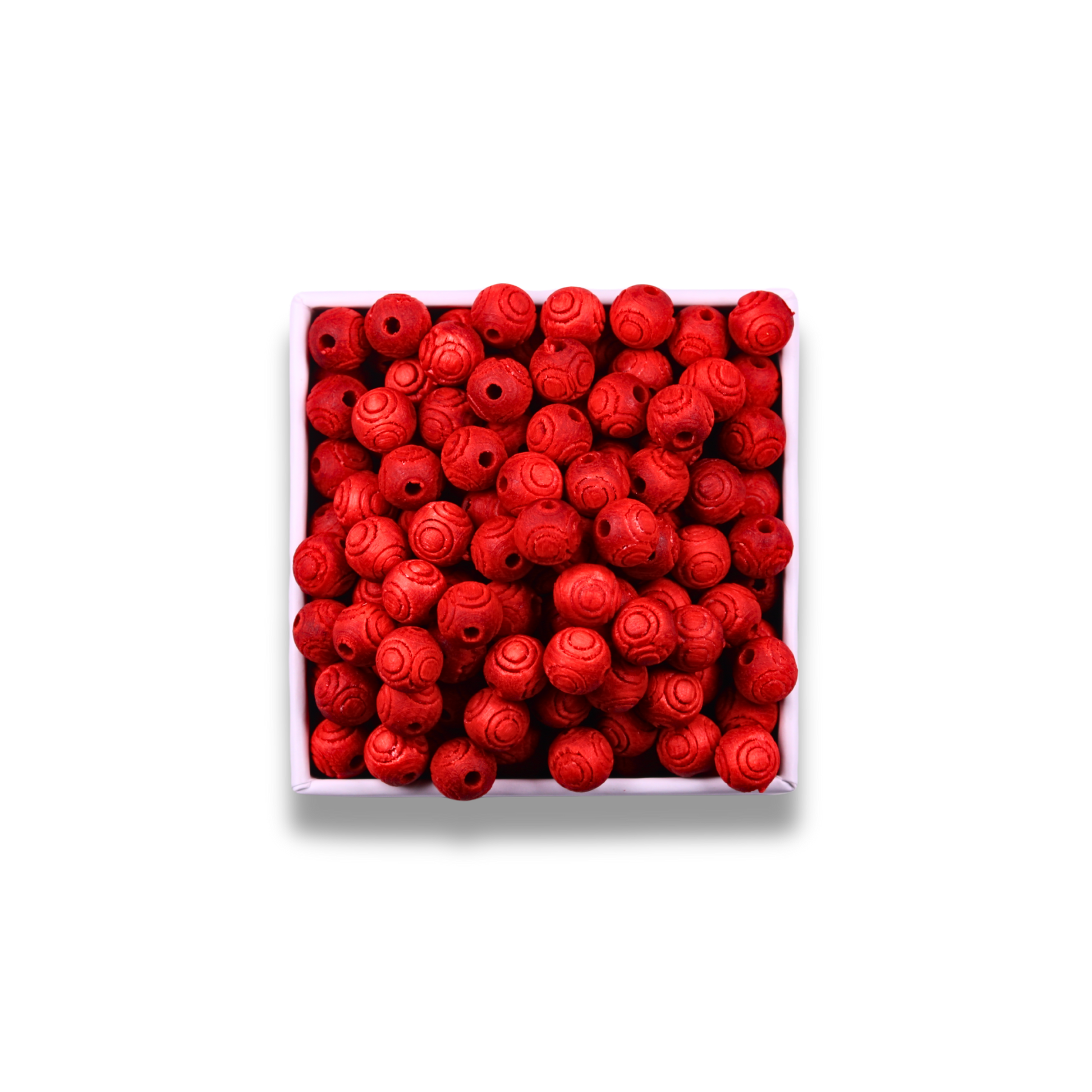 Box of red rose-shaped beads on a white background