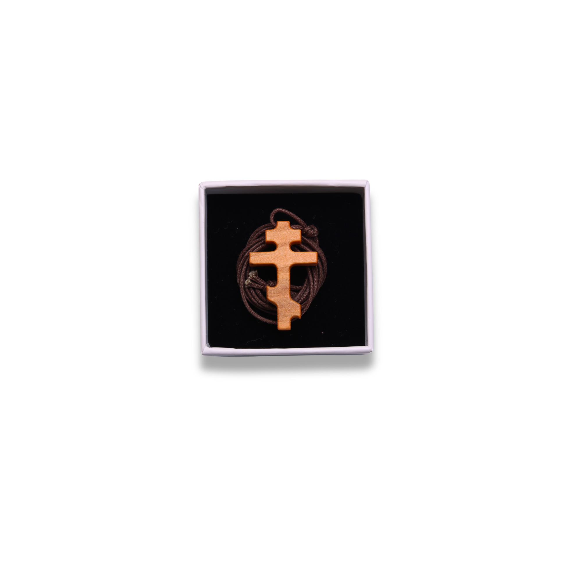 Russian orthodox olive wood cross pendant in a box on a white background