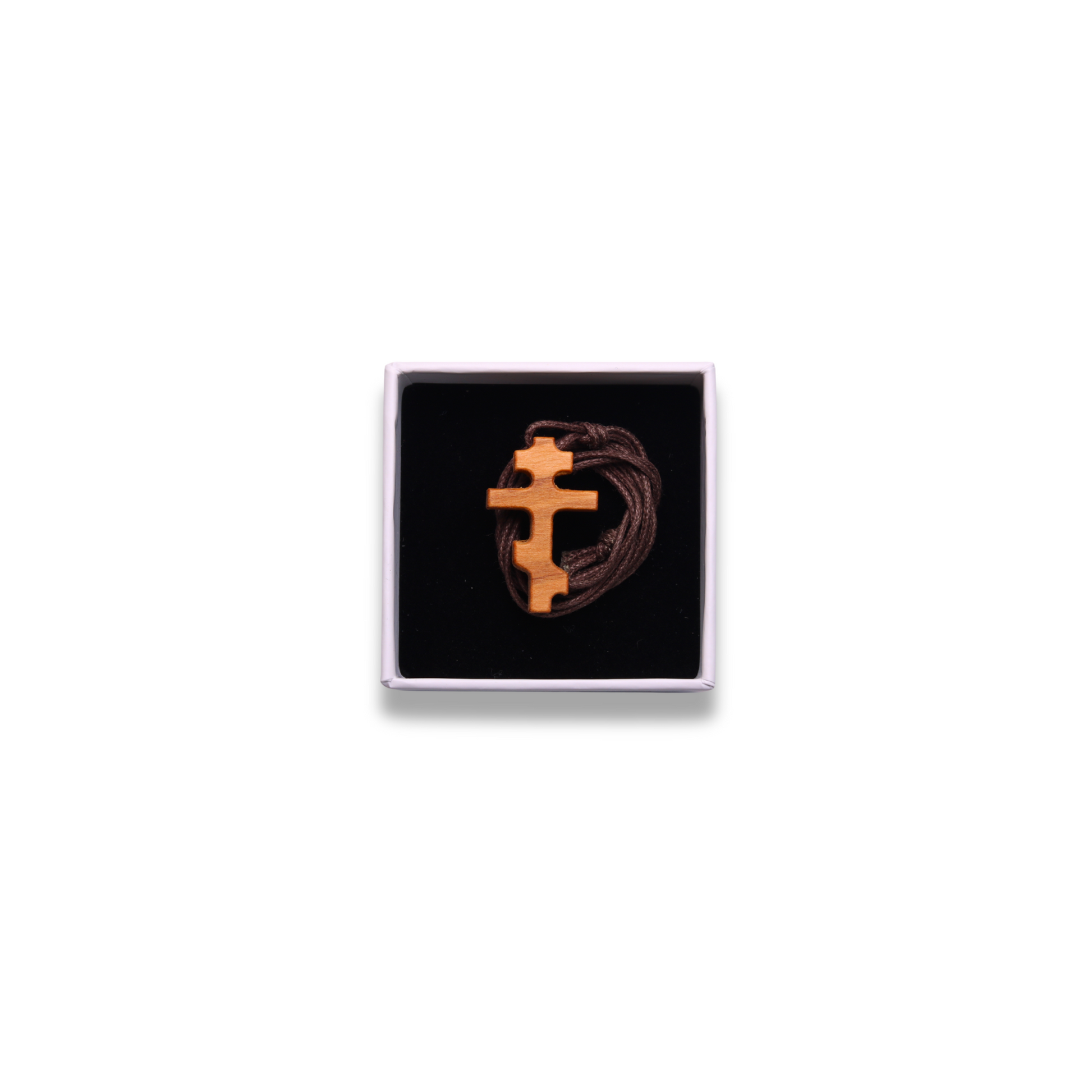 Russian orthodox olive wood cross pendant in a box on a white background