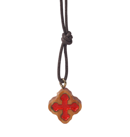  "A 'Crimson Embrace' Olive Wood Cross Pendant with a prominent red inlay, suspended on a dark brown cotton cord. The cross displays a natural wood grain, and the red inlay's glossy finish offers a striking contrast. Crafted by Christian families in the Holy Land, the pendant embodies a classic shape with balanced arms, representing a fusion of faith and artisan tradition."