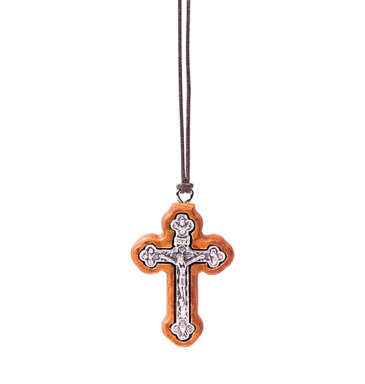 Olive wood orthodox crucifix pendant with detailed silver-tone metal representation of Jesus on the cross, suspended from a soft cotton cord.