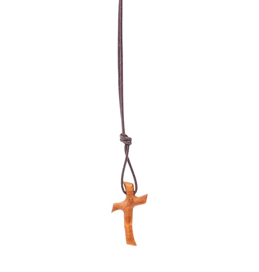 Olive wood cross pendant with a wavy design suspended from a soft cotton cord.