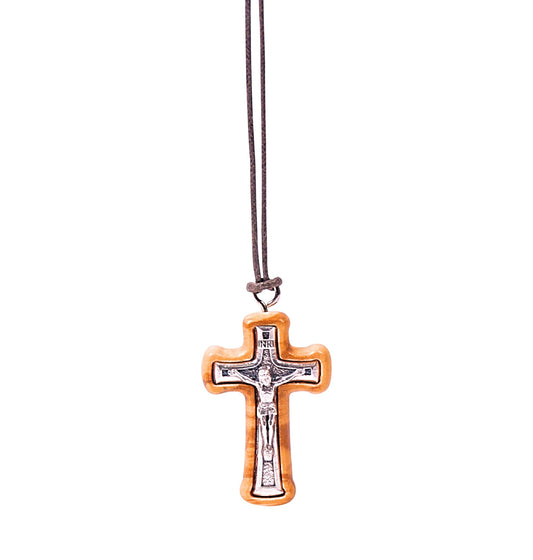 Olive wood crucifix pendant with a silver-tone metal Jesus figure and INRI sign on top, suspended on a soft cotton cord.