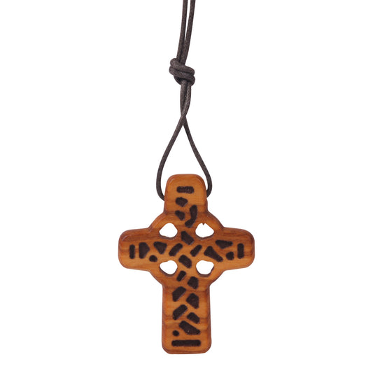 "An 'Eternal Faith' Olive Wood Cross Pendant, 4 cm high and 3 cm wide, with a rustic texture and visible grain, featuring a simple yet elegant design with a small loop for the dark cotton cord it hangs from. Handmade by Christian families in the Holy Land, the cross has a rich natural color with a smooth finish, conveying a sense of ancient tradition and spiritual dedication."