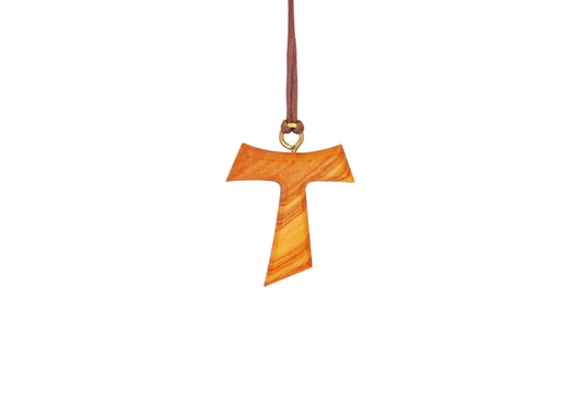 Tau Cross Pendant crafted from olive wood, exhibiting a T-shaped silhouette with widened ends, suspended on a brown cotton cord, symbolizing peace and spirituality from the Holy Land.