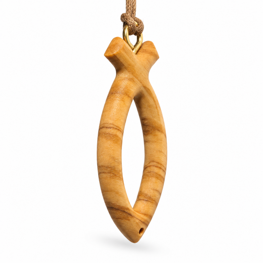 A carved olive wood fish-shaped pendant with a natural wood grain pattern, hanging from a brown cord with a gold-colored metal ring, shown against a plain white background.