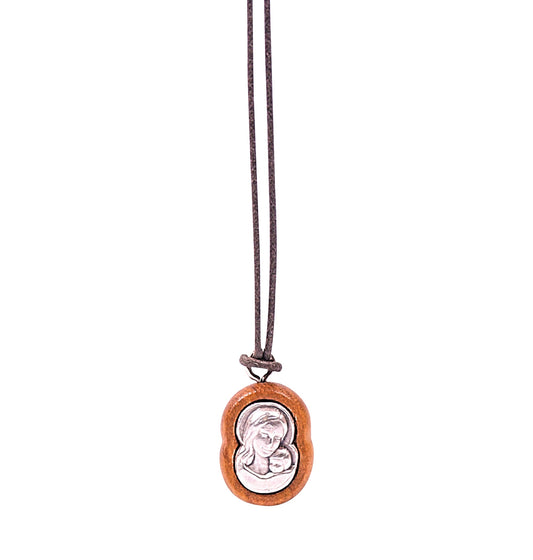 Olive wood pendant necklace shaped to the contours of the Virgin Mary cradling her child Jesus, with a detailed silver-toned metal inset of the duo inside the wooden frame, suspended from a soft cotton cord.
