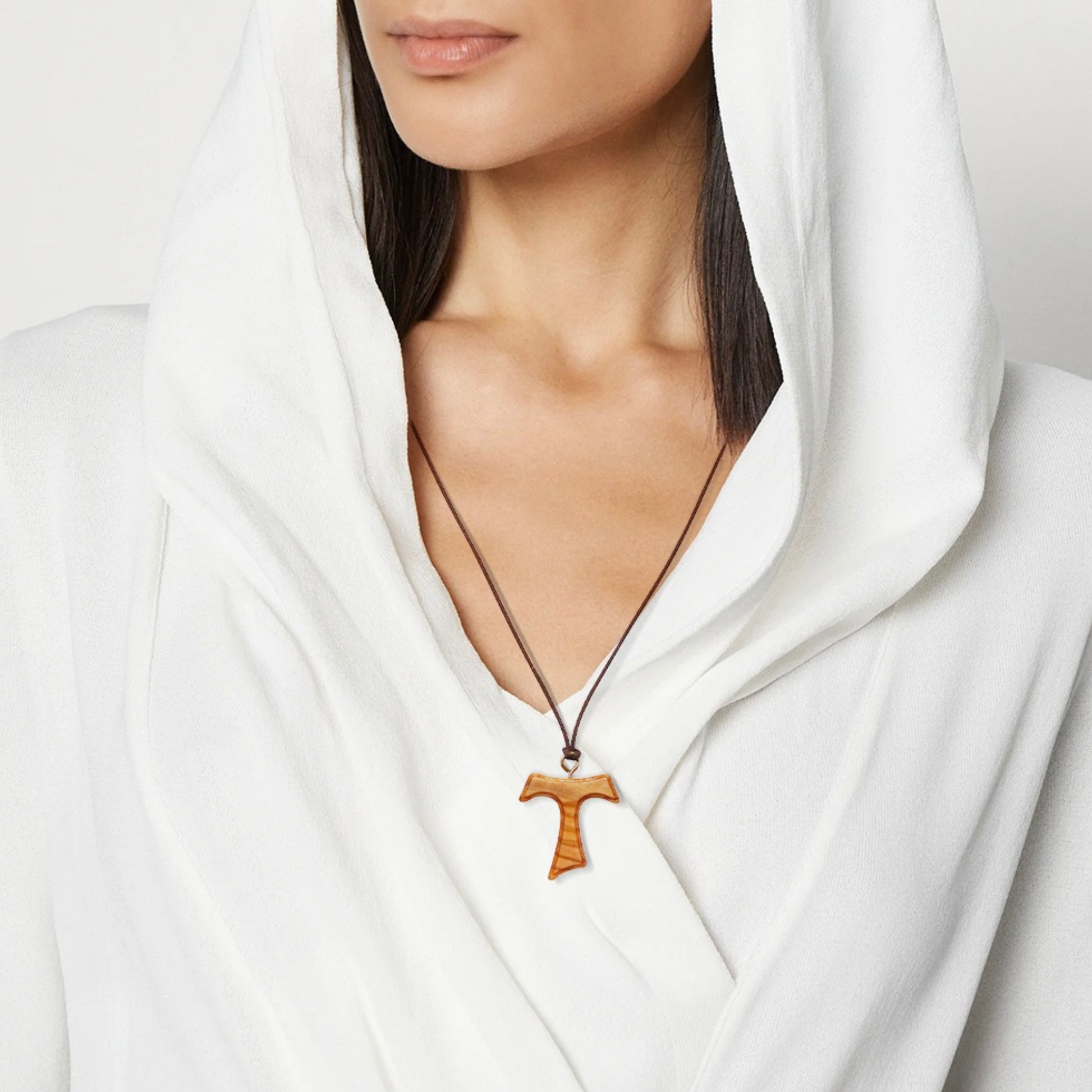 Woman wearing Tav Cross Olive Wood Necklace