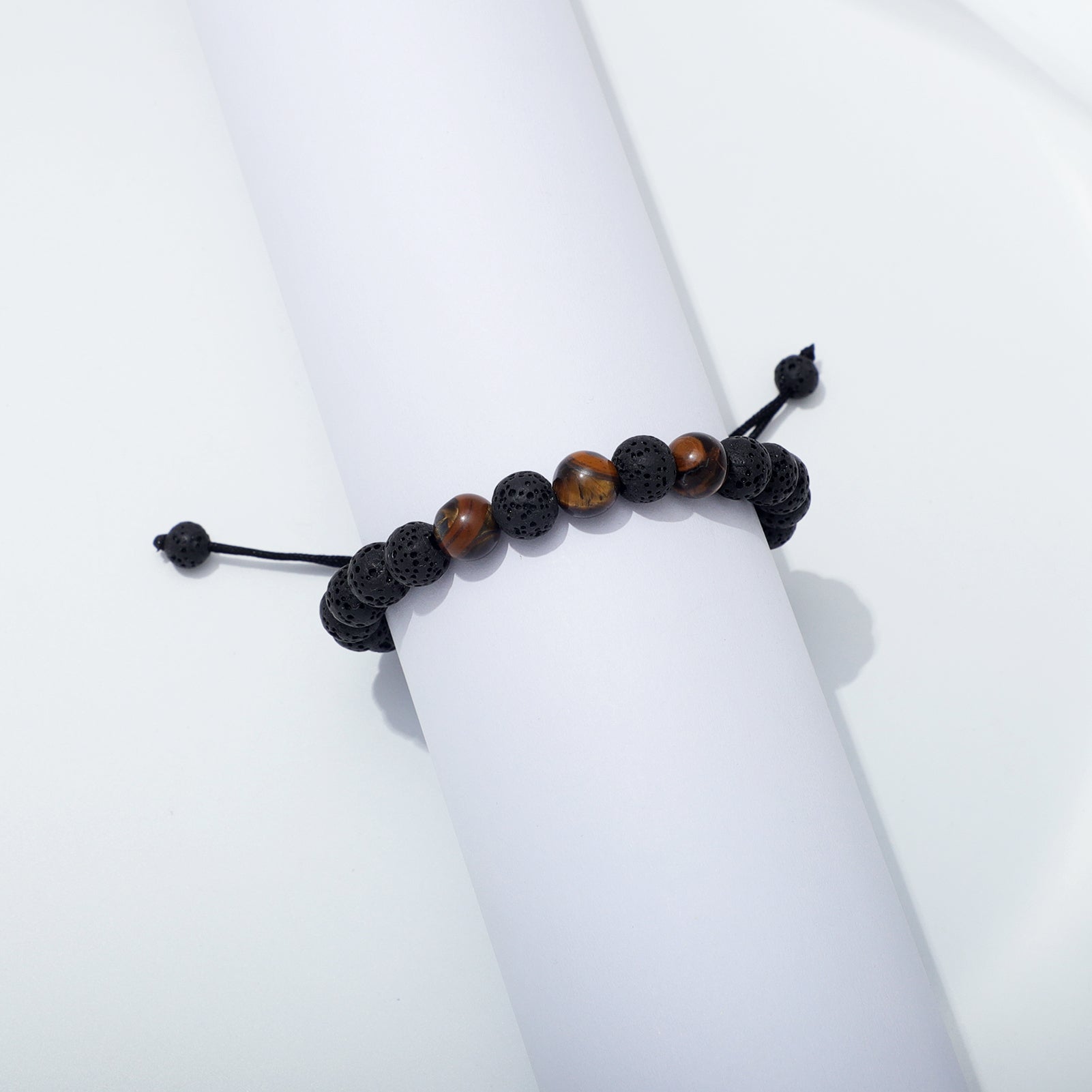 Tiger Eye and Lava Rock Bracelet Wrapped Around White Display Roll