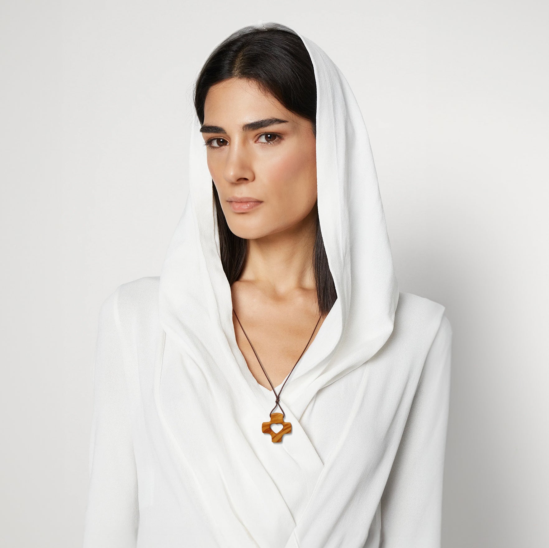 Woman wearing handcrafted olive wood cross from Nazareth Fair Trade