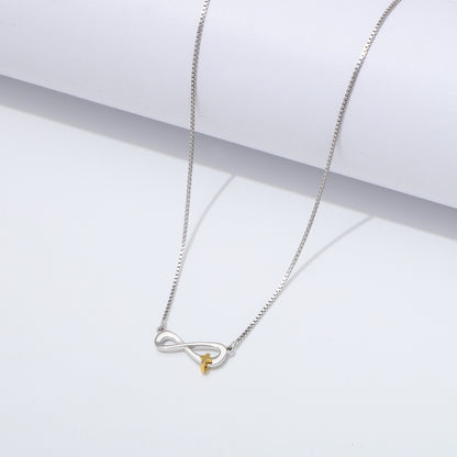 Silver 925 Sterling infinity necklace with a gold cross pendant on a white background