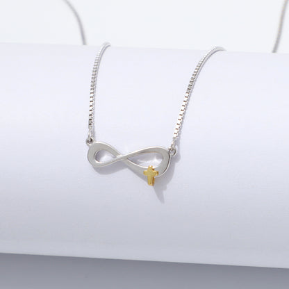 Silver 925 Sterling infinity necklace with a gold cross pendant on a white background