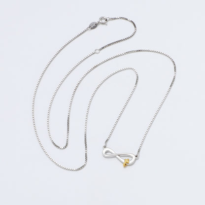 Silver 925 Sterling infinity necklace with a gold cross pendant on a white background