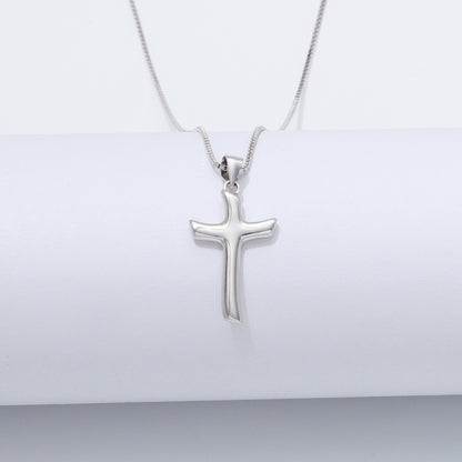 Silver cross pendant necklace on a white background