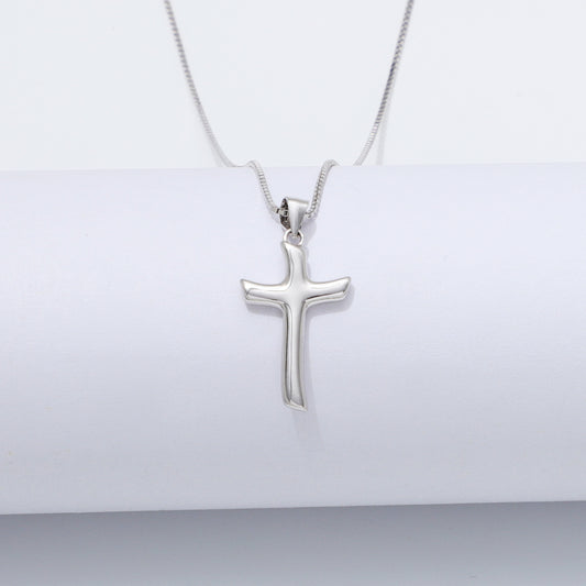 Silver cross pendant necklace on a white background
