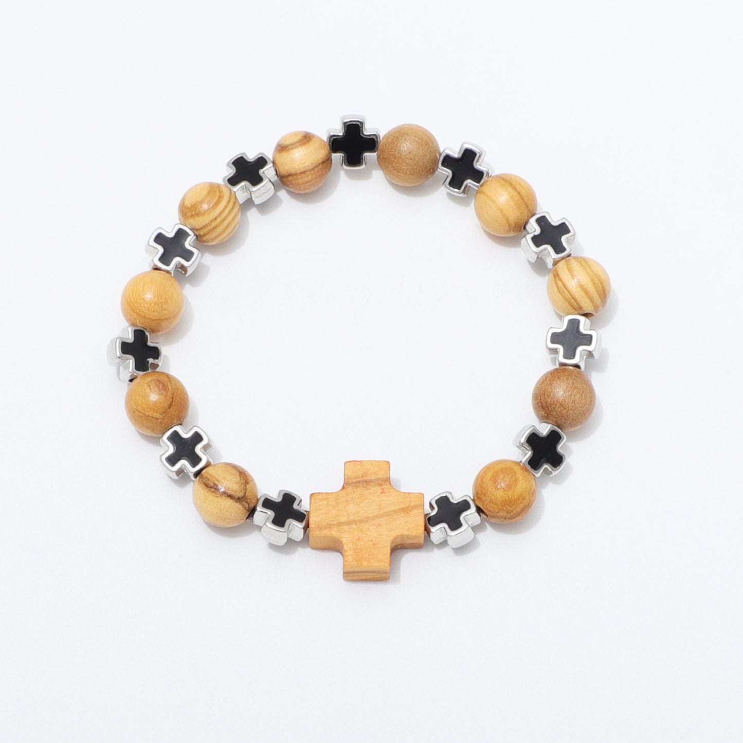 A beaded stretch bracelet featuring natural wood beads, black cross charms, silver cross charms, and a larger wooden cross centerpiece, displayed on a clean white background.