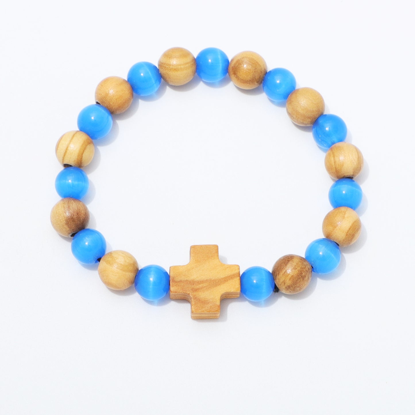A beaded bracelet featuring alternating light blue and natural wood beads, with a central wooden cross charm, displayed on a clean white background.