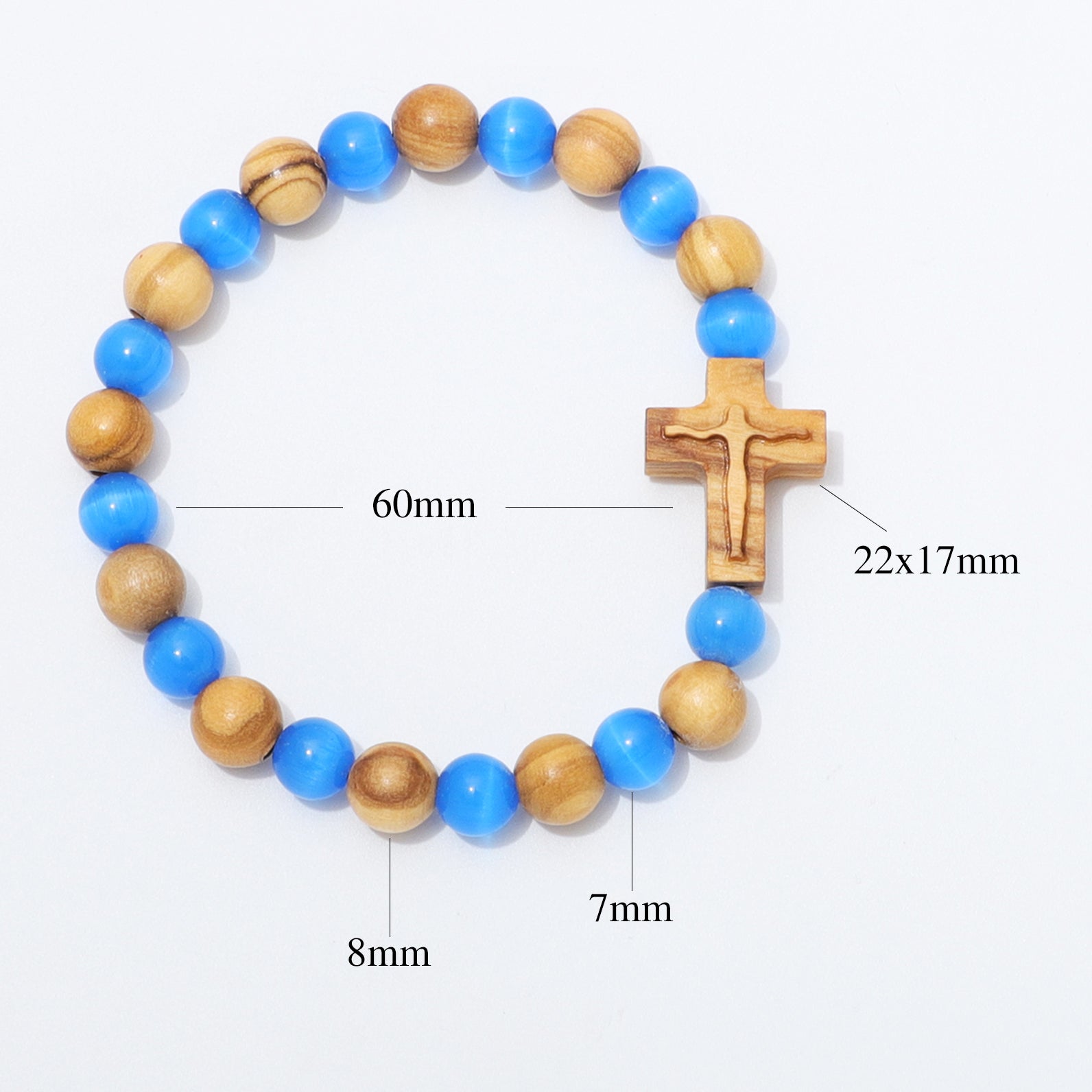 A beaded bracelet with alternating blue and natural wood beads, featuring a wooden crucifix pendant. Black measurement lines and text labels indicate dimensions: 60mm for the bracelet circumference, 22x17mm for the crucifix, 8mm for some beads, and 7mm for others, all on a plain white background.