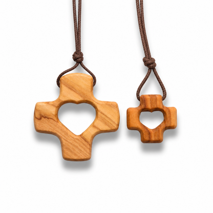 Two wooden cross necklaces with heart cutouts on a white background