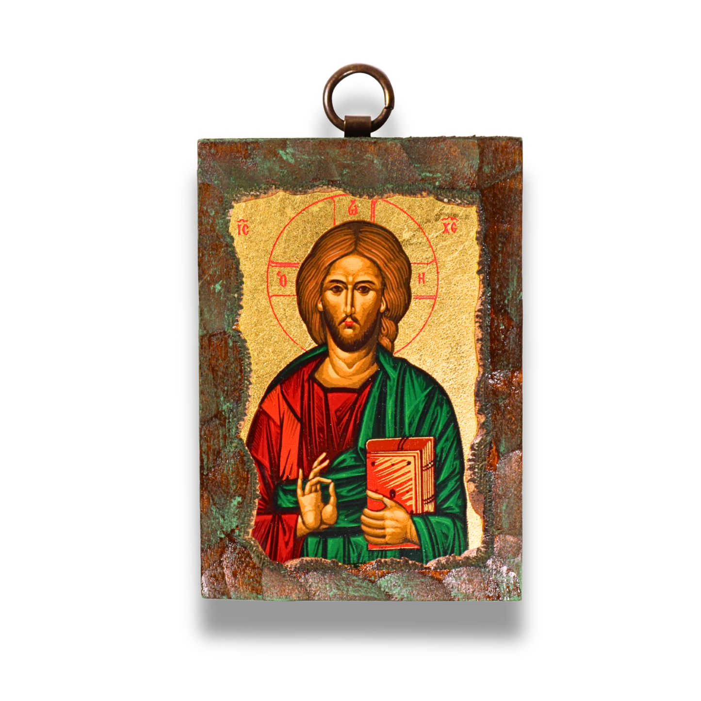 An ornate Byzantine icon of Jesus Christ on a wooden panel, with a gold-leaf background. Christ is shown with a red and gold halo inscribed with Greek letters, a solemn expression, brown hair, and a beard. He wears a red tunic and a green cloak, his right hand raised in blessing, and his left holding an open book with Greek script. The icon has a dark, textured border with a metal loop for hanging at the top.