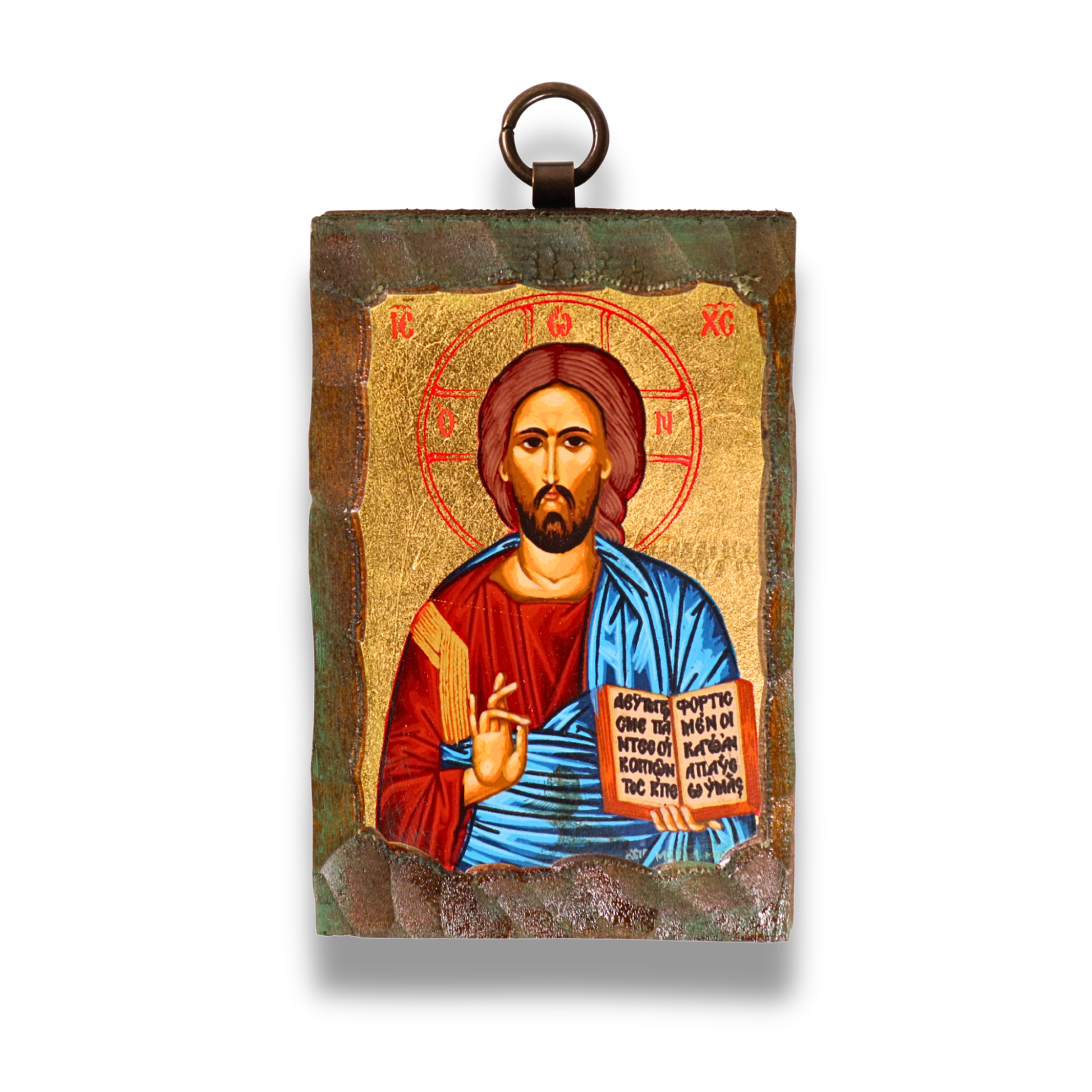 An ornate Byzantine icon of Jesus Christ on a wooden panel, with a gold-leaf background. Christ is shown with a red and gold halo inscribed with Greek letters, a solemn expression, brown hair, and a beard. He wears a red tunic and a blue cloak, his right hand raised in blessing, and his left holding an open book with Greek script. The icon has a dark, textured border with a metal loop for hanging at the top.
