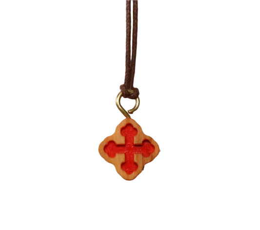 The "Crimson Embrace" Necklace blends artistic expression with sacred tradition. A vivid red inlay at the heart of the olive wood cross symbolizes passion and life.
