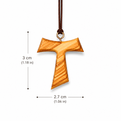 A wooden cross pendant with a natural wood grain finish, hanging from a dark brown cord. Black dimension lines and text indicate a height of 3 cm 