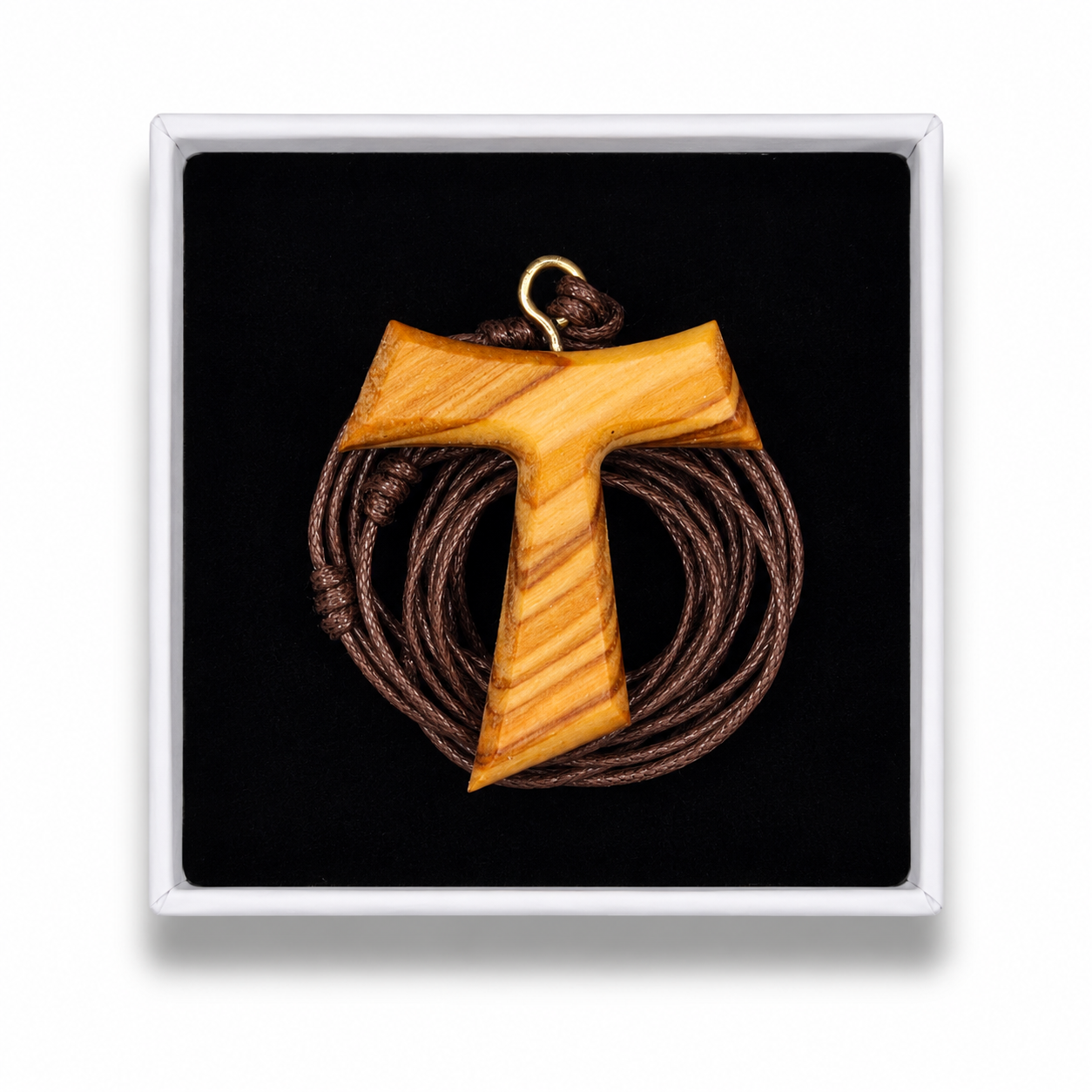 A wooden T-shaped pendant with a natural grain finish and a small gold loop at the top, displayed on a black background inside a white square presentation box.