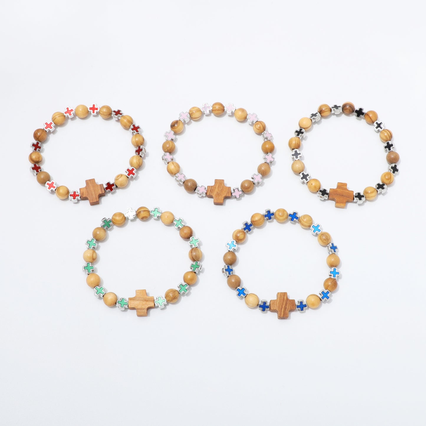 Five wooden beaded bracelets with cross charms arranged on a plain white background.