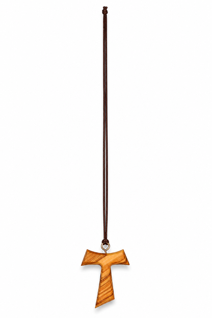 A wooden cross pendant with a natural wood grain finish, suspended on a dark brown cord necklace against a plain white background.