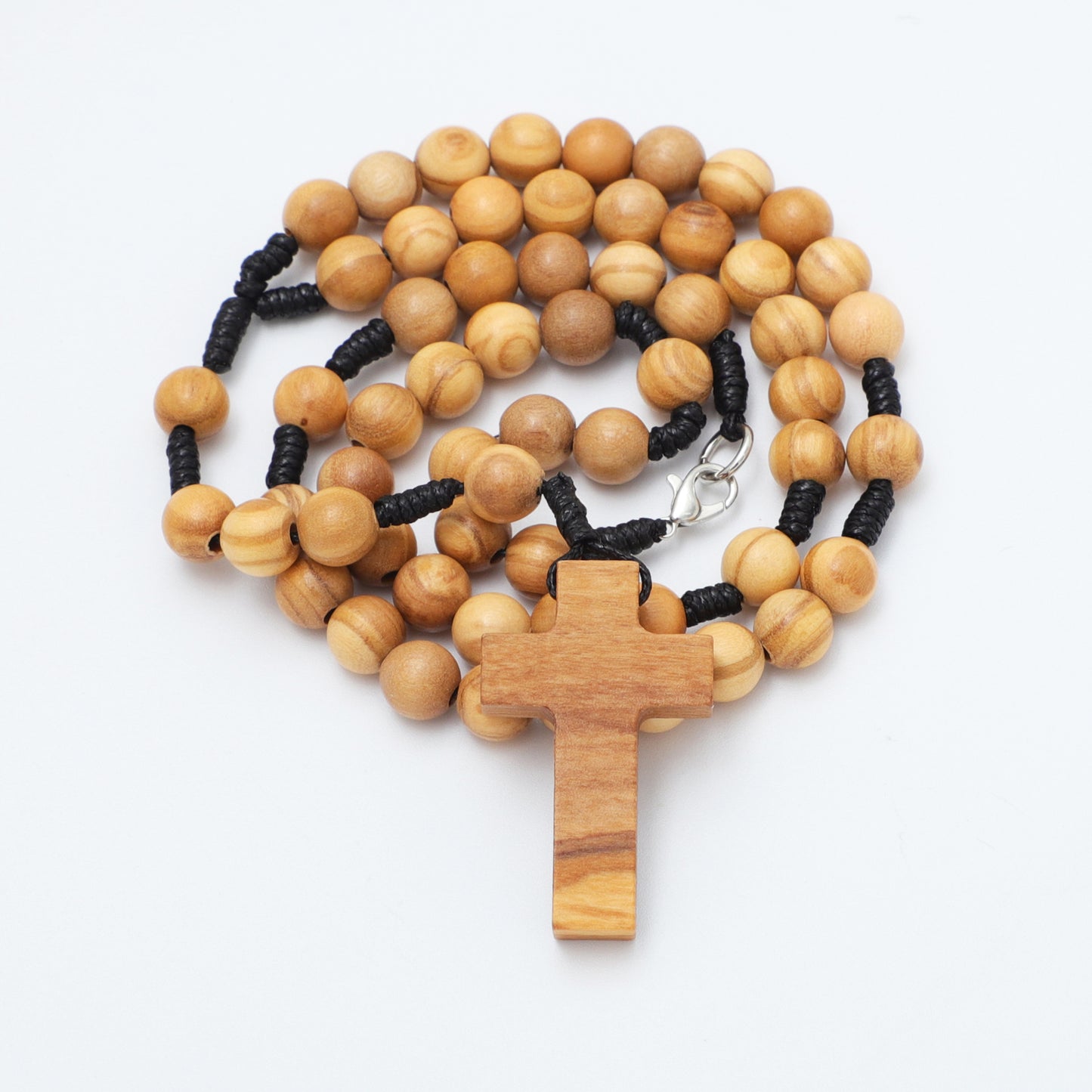 Wooden rosary with a cross on a white background