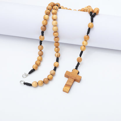 Wooden rosary with a cross pendant on a white surface