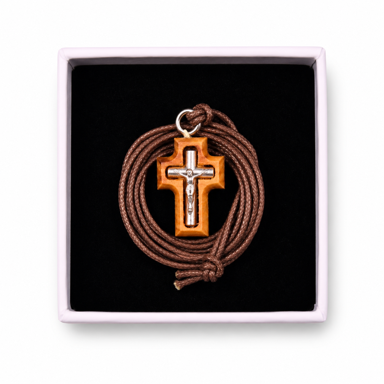 Cross pendant with brown cord in a black box
