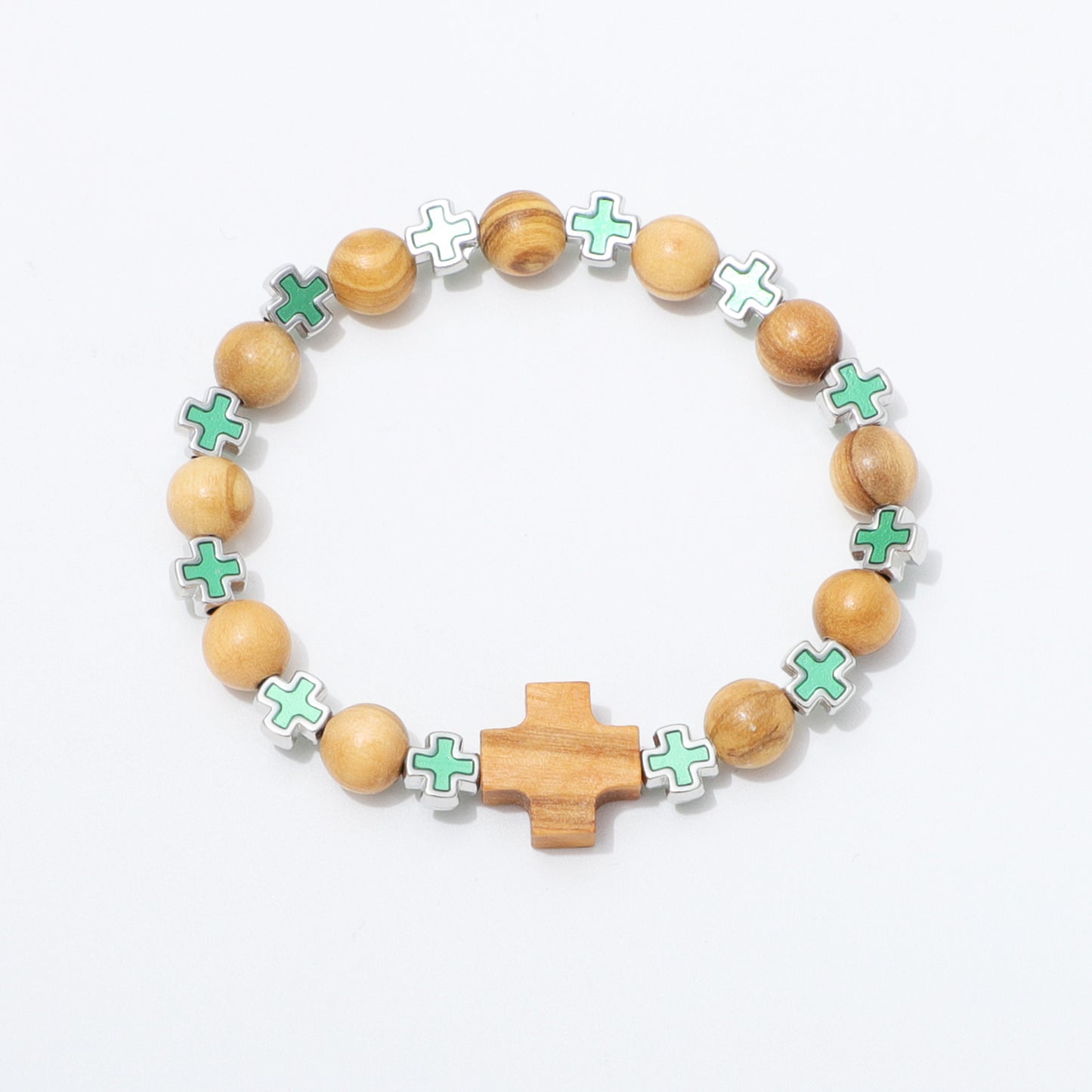 A beaded bracelet featuring natural wood beads, a central wooden cross, and alternating mint green and white enamel cross charms on a white background.