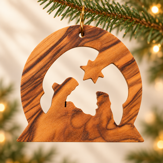 A round wooden Christmas ornament with a cutout silhouette of a family and a star, hanging from a pine branch with warm blurred lights in the background.