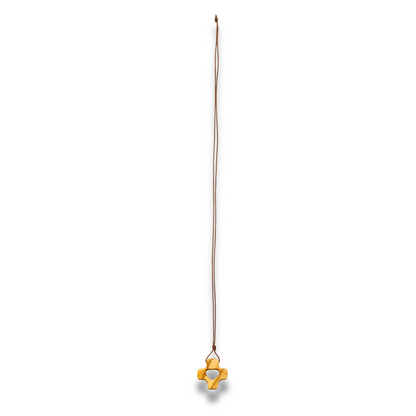 A gold pendant necklace featuring a stylized cross with a heart cutout in the center, suspended from a thin brown cord against a plain white background.
